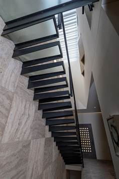 Staircase to second floor with master bedroom
