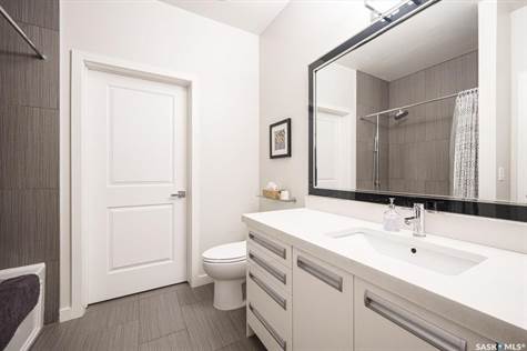 Large 4pc bathroom with walkthrough to laundry/storage room.