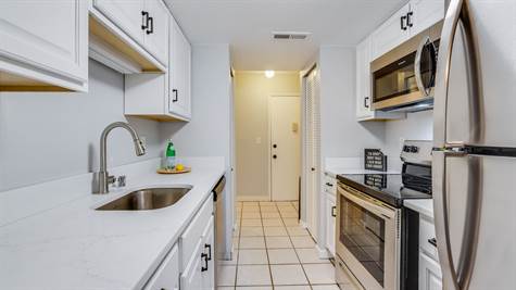 Clean and bright kitchen with ample counter space and storage.