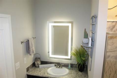 BOTH MASTER BATHS HAVE LIGHTED MIRRORS