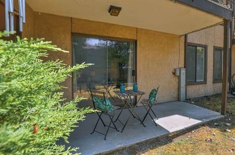 Peaceful patio overlooking lawn and greenery. Additional storage closet off patio.