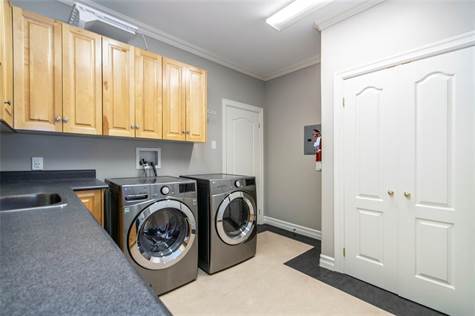 Laundry storage and mud room area off garage