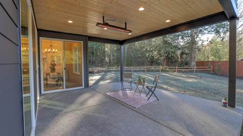 Extended, covered patio with toasty heating fixture and recessed lighting. Plumbed for barbecue for effortless grilling.