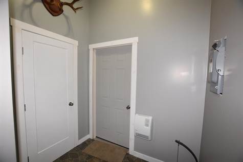 Inside the main entry - one door is a closet the other goes to the garage 