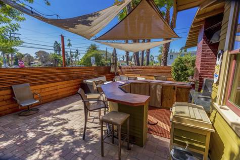 Entertainer's Yard, with a large built-in Bar, that offers 2 Fridges, a TV, a Beer Keg, a built-in Ice Chest, built-in Bose Speakers, Sail Shades & Cafe Lights, all of which are being sold with the home.