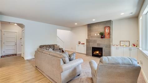 Floor to ceiling stone fireplace with built in cabinets on either side.