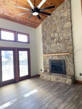 Tall ceiling and stone fireplace
