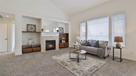 Gas fireplace with custom built-ins on either side.  The vaulted ceilings throughout this home keep it light and bright.