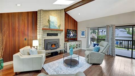 Living room with hardwood flooring, toasty wood burning stove.