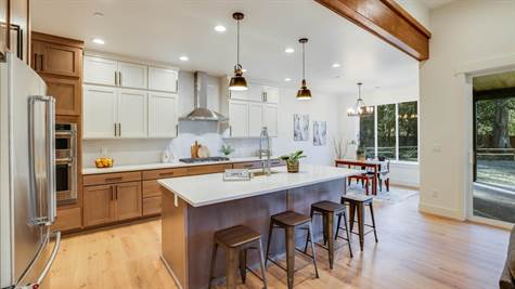 Quartz counters, extended height upper cabinets. Large island with ample seating.