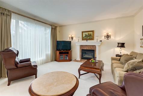 This is a spacious and bright family room with a second fireplace.