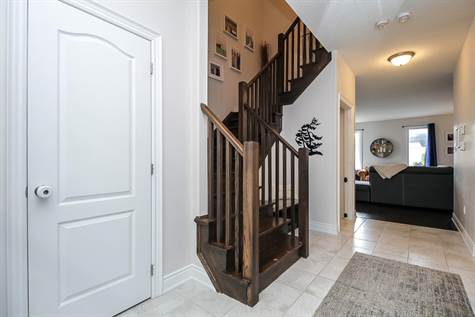 winding staircase leads to bedrooms and laundry room on 2nd floor