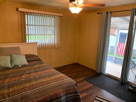 Guest bedroom with a sliding door to the screened prch