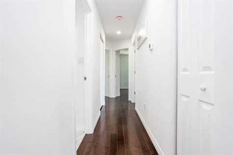 Hallway w/Hardwood Floors Leading to Bedrooms & Bath