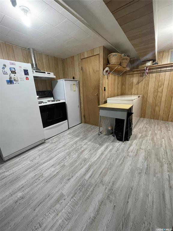 Utility room with cooking and cold storage appliances, new vinyl plank flooring