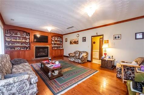 FAMILY ROOM WITH HARDWOOD FLOORS, GAS FIREPLACE, BUILT IN SHELVES