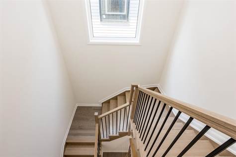 Upgraded Oak Hardwood Stairs w/Iron Spindles lead to the 2nd floor w/Great size Window letting in tons of natural light