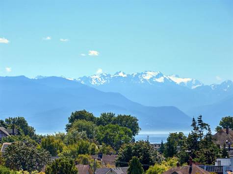 LOOKING OVER THE STRAIT OF JUAN DE FUCA TO THE OLYMPIC MOUNTAINS IN THE DISTANCE