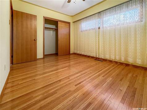 Unfurnished bedroom featuring ceiling fan, light hardwood / wood-style flooring, and a closet