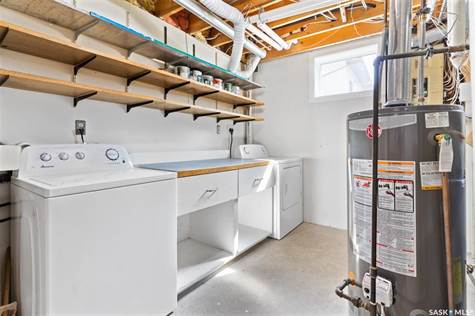 basement utility room with suite laundry