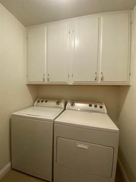 Laundry Room with white cabinetry