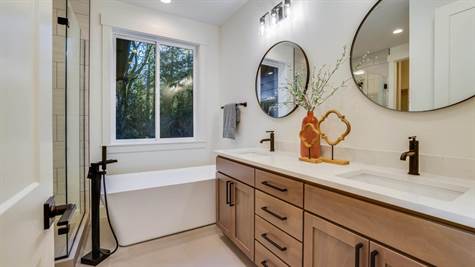 Primary ensuite with double sink vanity, quart counters and free-standing tub.