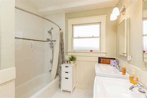 Spacious Guest Bathroom, with "Vintage Like" Floor Tile, Subway Tile in the Shower & 2 Petal Stool Sinks.