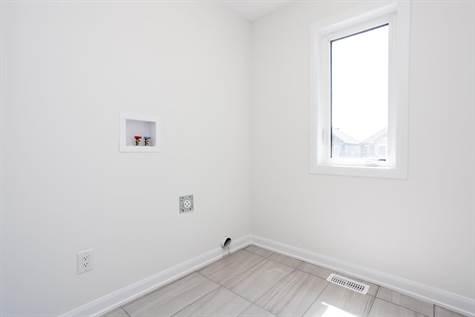 Convenient 2ND LEVEL Spacious Laundry Room w/Upgraded Tile Floors & Window