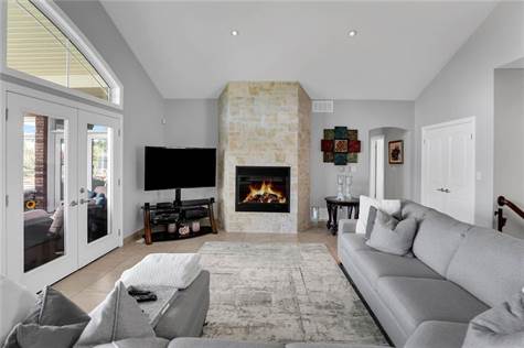Cozy gas fireplace, pot lights and vaulted ceilings