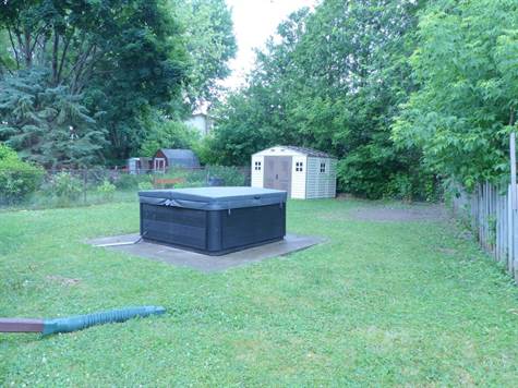 The rear yard is fenced and has a newer hot tub