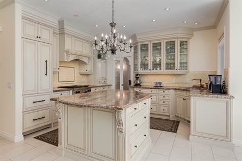 The French country kitchen is an elegant, balanced room with plenty of cabinets.