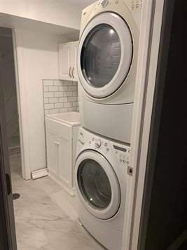 Private suite full sized laundry room with tub