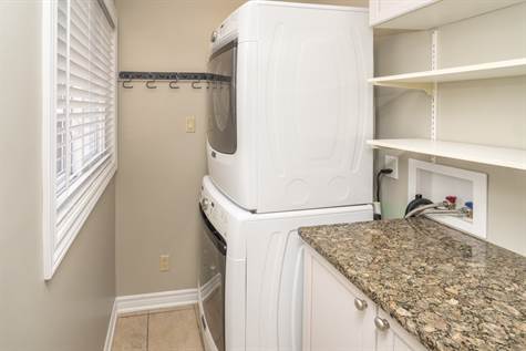 Convenient Main Floor Laundry w/Shelves & Storage w/Granite Top