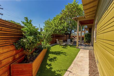 Entertainer's Yard, with a large / mature Pepper Tree, a large Privacy Fence, that has Sound Proofing Material inside the Fence & an Easy Turf Lawn.