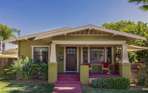Fresh paint & large mature palm trees, add to the charm of this renovated, historic Craftsman home.